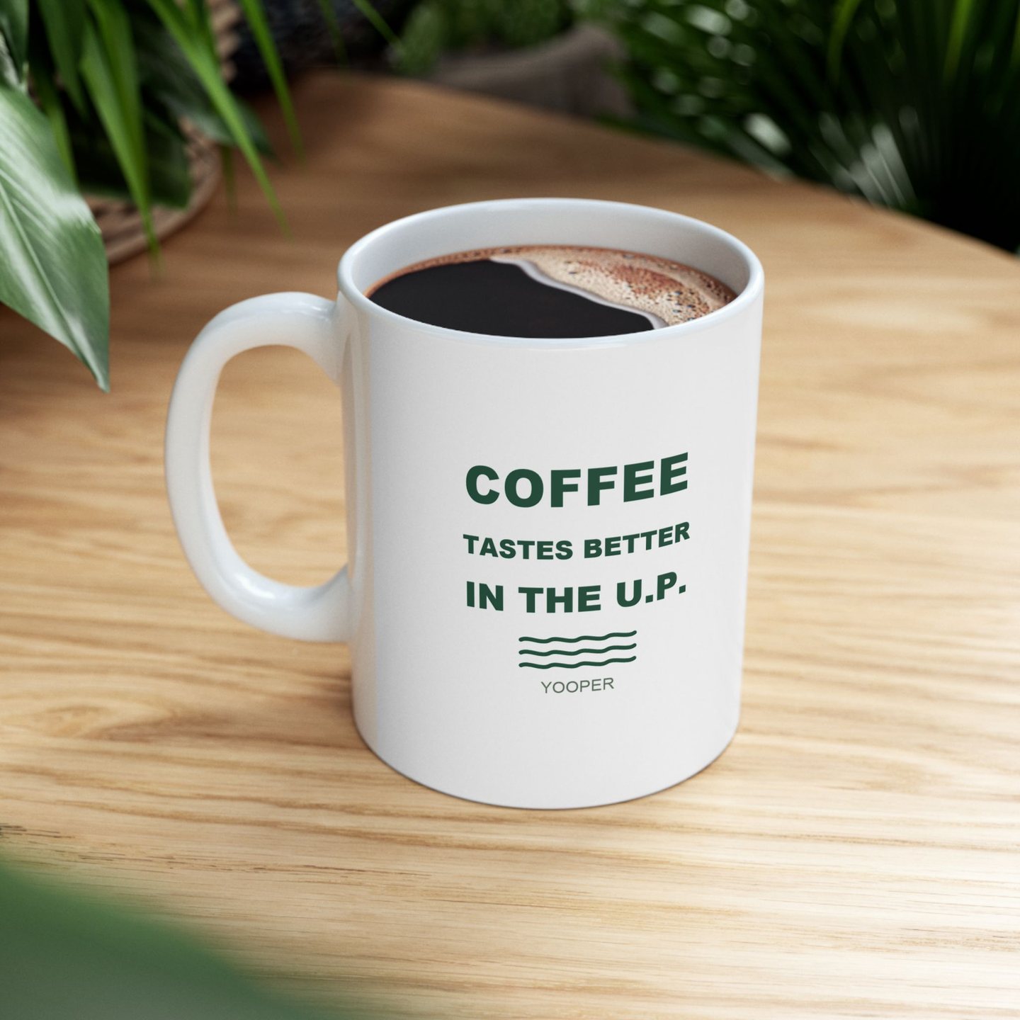 Coffee Tastes Better in the U.P. mug filled with coffee on a wood table