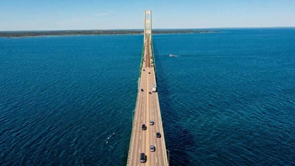 Aerial view of the Mackinac Bridge crossing blue water.