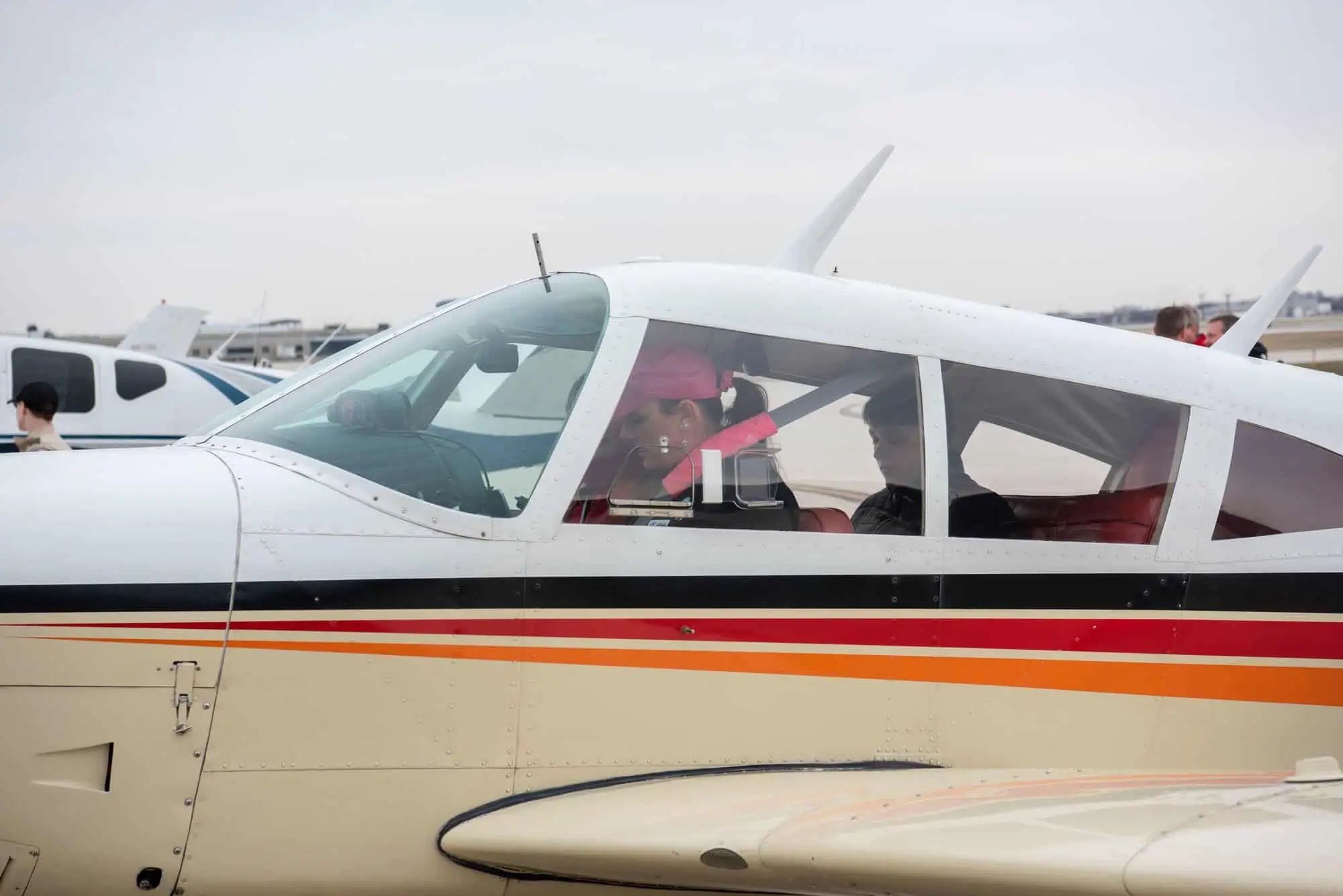 Volunteer pilot and young passenger seated inside a small general-aviation airplane before a Young Eagles flight.