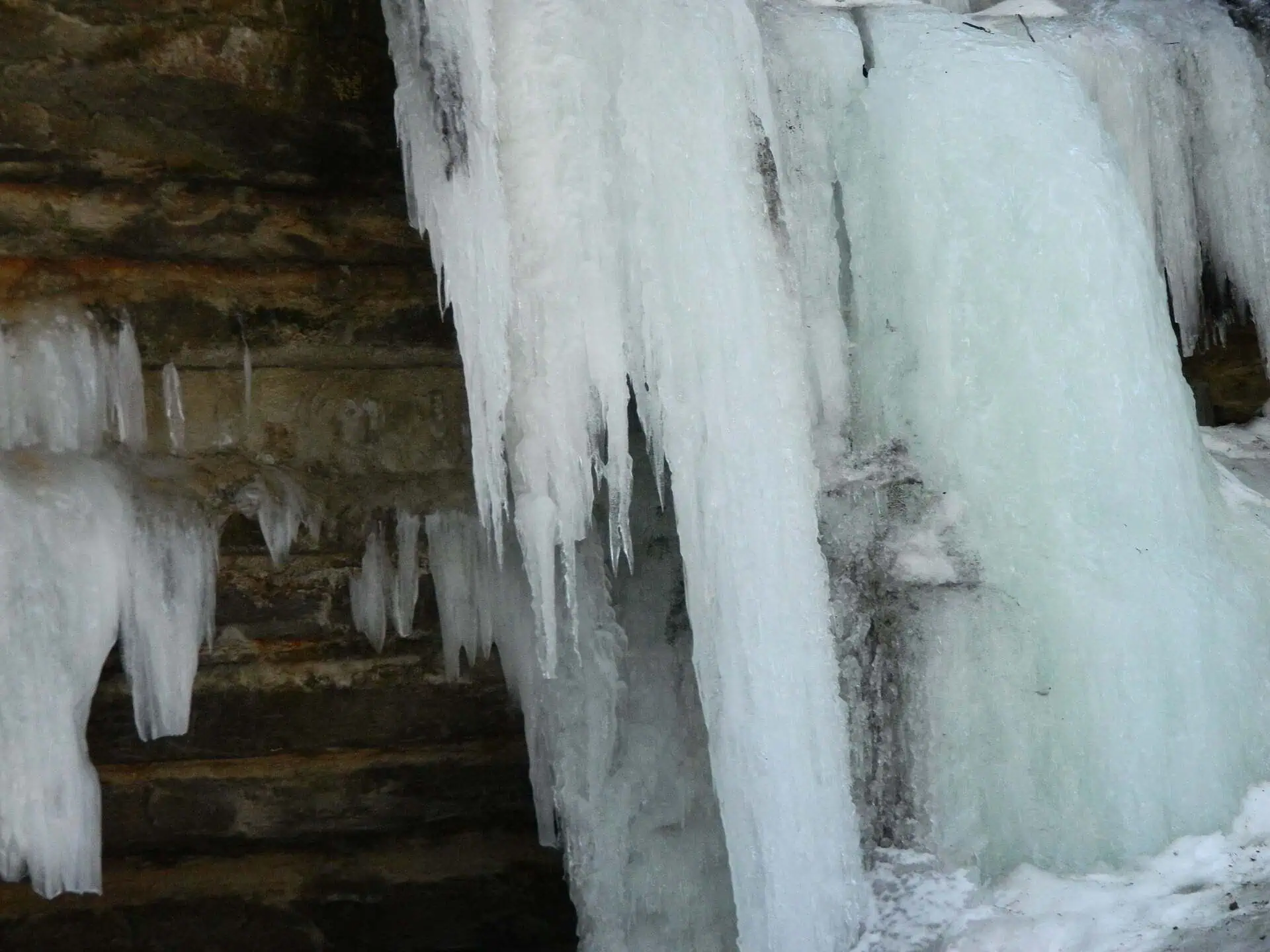 Thick columns and spears of ice hanging from a sandstone overhang at the Eben Ice Caves in Michigan.