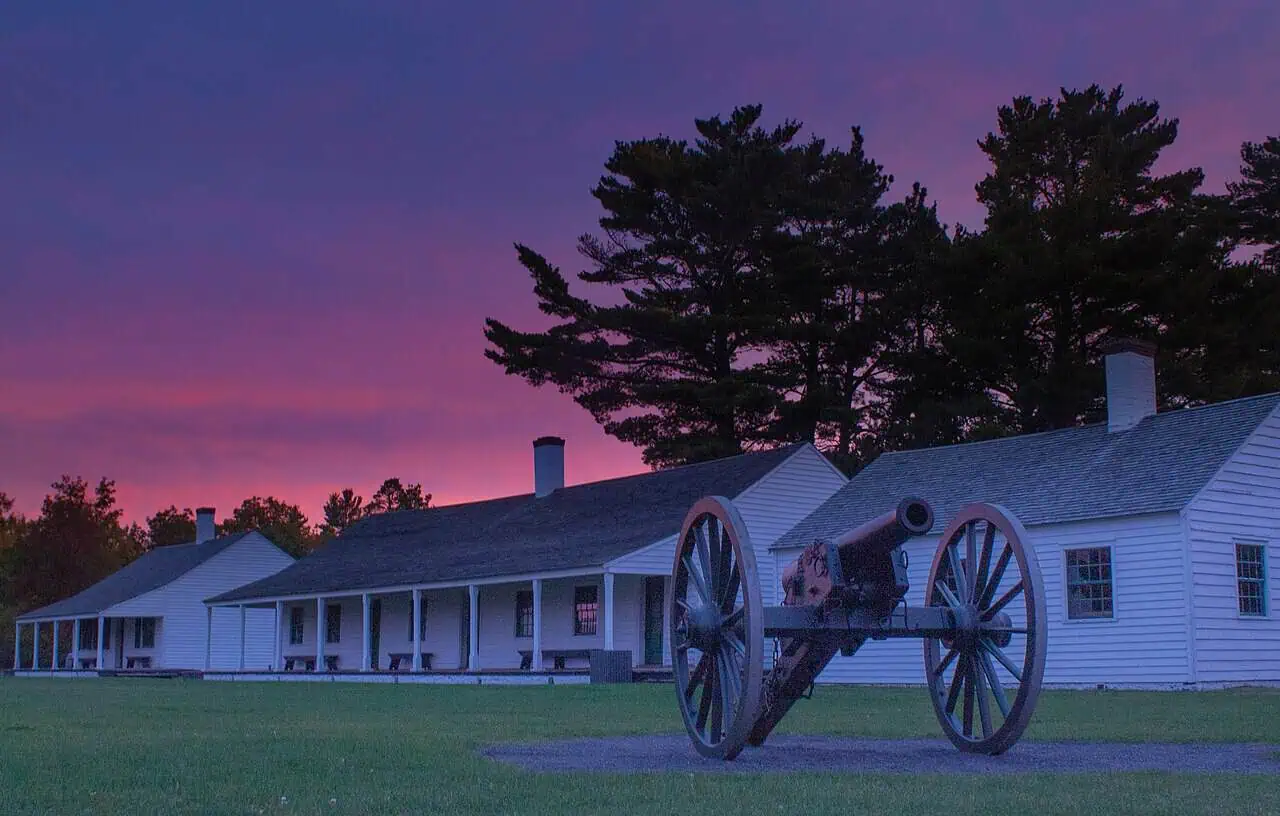 The restored wooden buildings and stockade of Fort Wilkins at sunrise in Copper Harbor, Michigan.