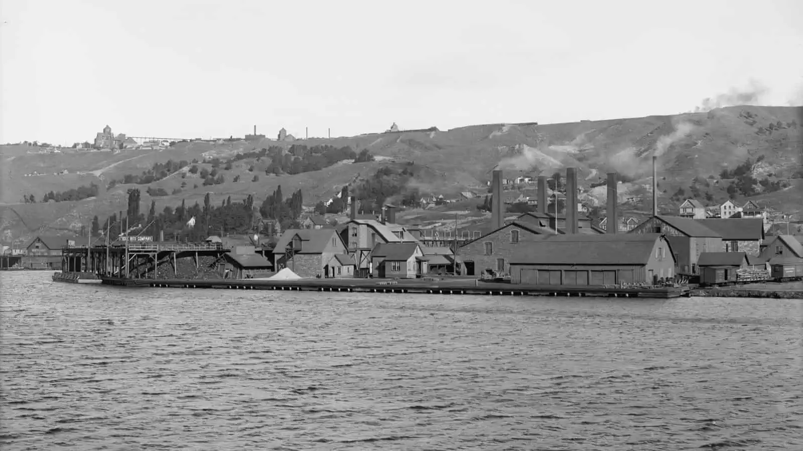 The Quincy Smelting Works on the Portage Lake shore at Ripley, Michigan, around 1906, with its stacks and long shed roofs along the water.