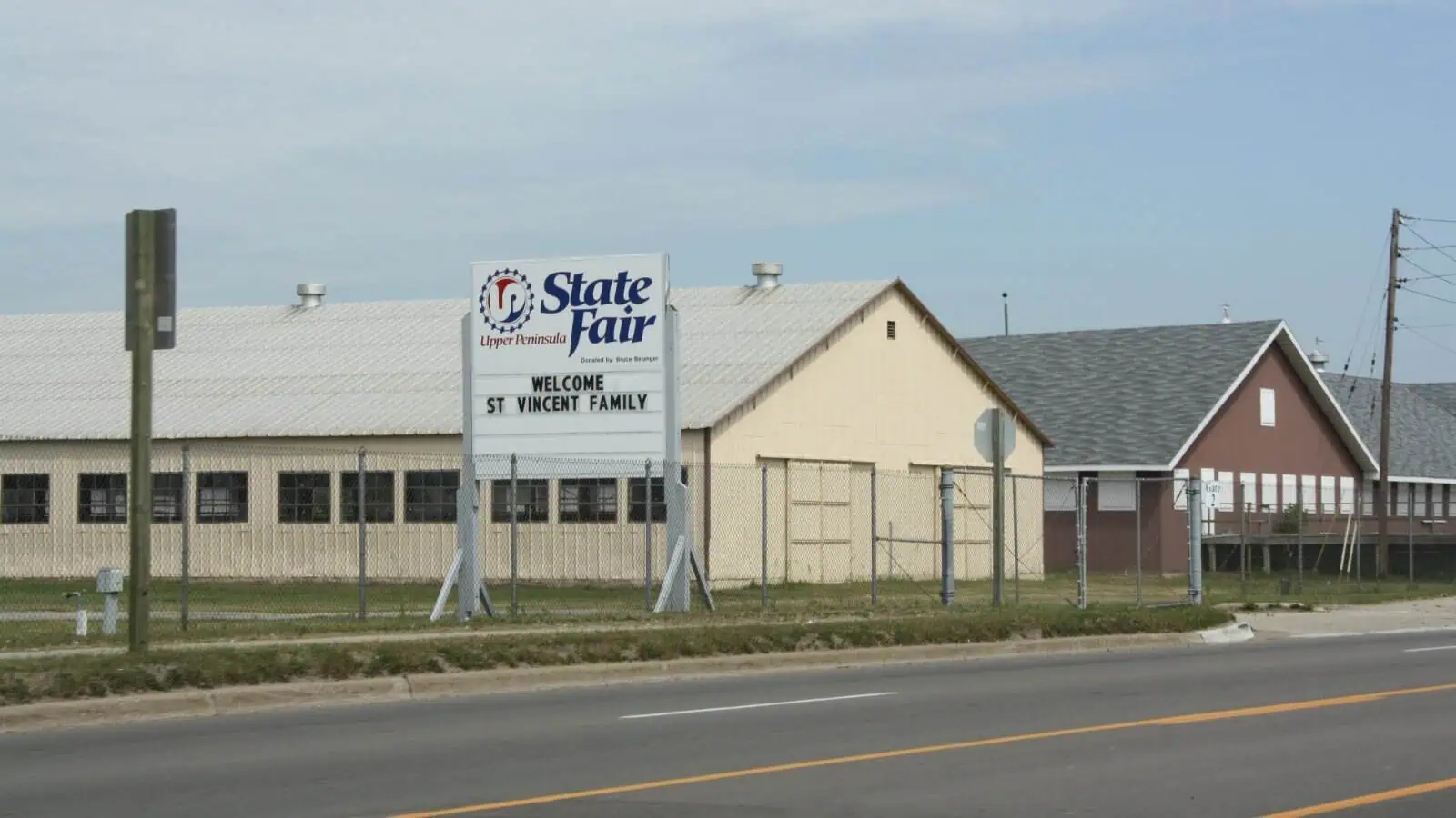The Upper Peninsula State Fair sign and exhibition buildings on the fairgrounds in Escanaba, Michigan.