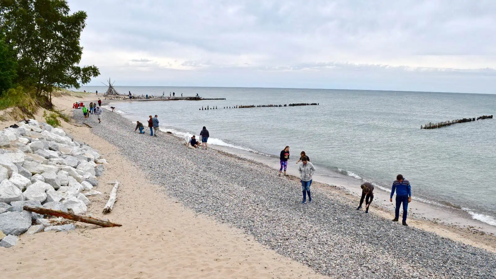 The shoreline at Whitefish Point, with Lake Superior stretching to the horizon and old pier cribs standing in the shallows.